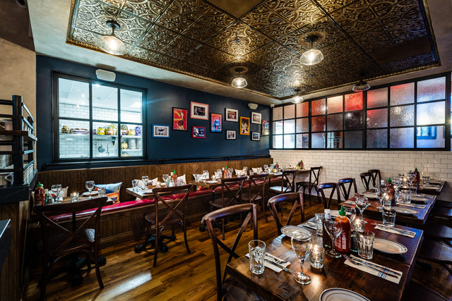 Ornate gold tin ceiling acoustic tiles in cozy restaurant 