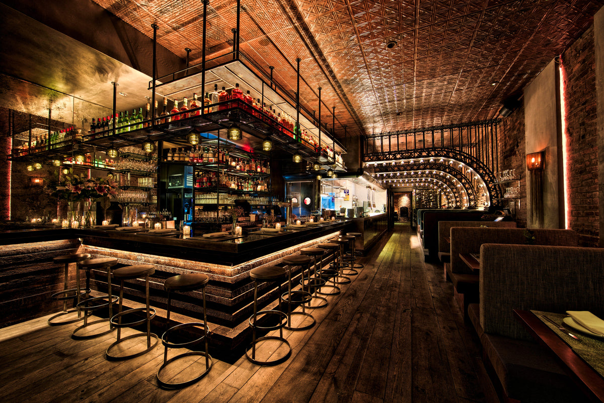 Ornate copper tin ceiling tiles with a Victorian pressed pattern in a restaurant. 
